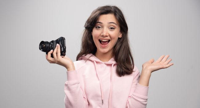 young women posing with a camera